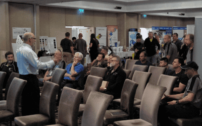 Industry speaker delivering a presentation to carpet cleaning professionals at a WA expo event.